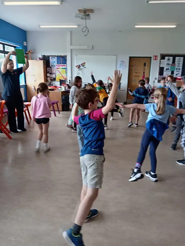 Children in a music class movement activity