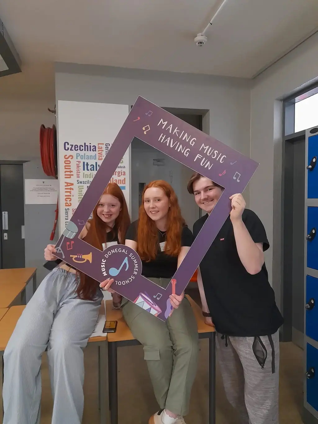 Students posing with a Making Music frame